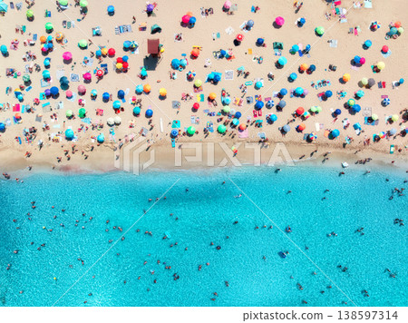 Aerial view of colorful umbrellas on sandy beach, swimming people Aerial view of colorful umbrellas on sandy beach, swimming people 138597314