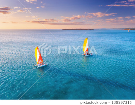 Aerial drone view of sailboats on blue sea at sunset Aerial drone view of sailboats on blue sea at sunset 138597315