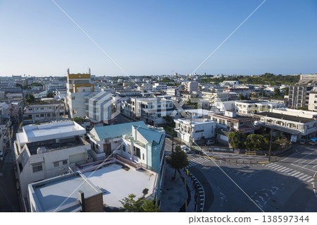 A clear, sunny day in downtown Miyako Island, at the intersection in front of the public market. A clear, sunny day in downtown Miyako Island, at the intersection in front of the public market. 138597344