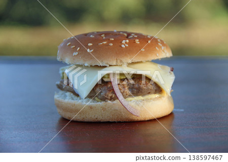 Cooking burger outdoors. Outdoor food. Fast food ready to eat. Tasty fast food Cooking burger outdoors. Outdoor food. Fast food ready to eat. Tasty fast food 138597467
