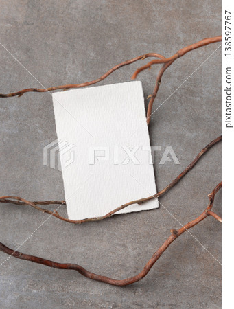 Blank card mockup on grey stone with dry branches, copy space. Minimal rustic stationery template 138597767