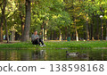 Young man working on laptop in riverside park, 4K 138598168