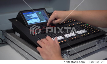 Man controlling professional lighting mixer using stylus 4k Man controlling professional lighting mixer using stylus 4k 138598170