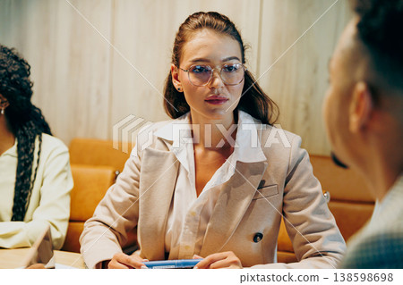 Professional person attentive during discussion while referencing charts Professional person attentive during discussion while referencing charts 138598698
