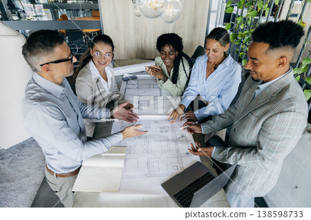 Professionals assessing blueprints and providing detailed feedback 138598733