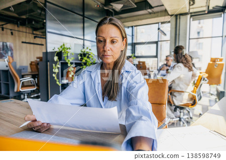 Recruiter examines resumes with focus on diverse applicant backgrounds 138598749