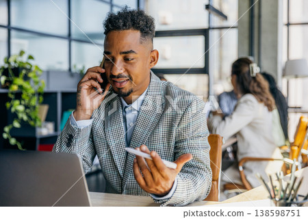 Confident businessman negotiating deal with client in office environment Confident businessman negotiating deal with client in office environment 138598751