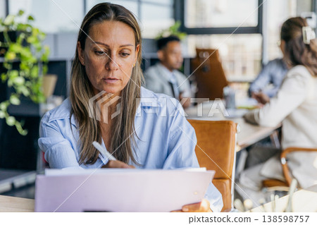 Diligent Analyst Meticulously Scrutinizing Financial Statements With Attention To Detail And Precision Diligent Analyst Meticulously Scrutinizing Financial Statements With Attention To Detail And Precision 138598757