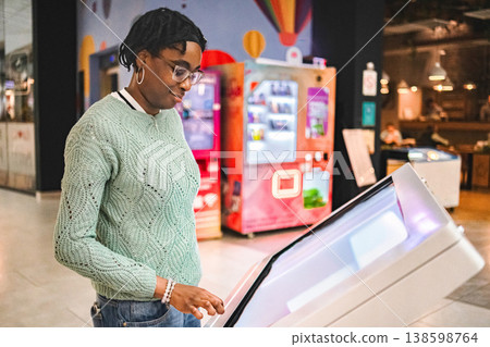 Woman using interactive digital kiosk for information display 138598764