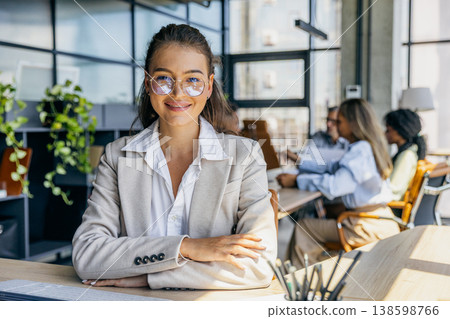 Caucasian marketing chief shows warm smile with arms crossed Caucasian marketing chief shows warm smile with arms crossed 138598766