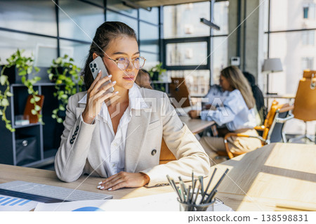 Confident Sales Representative Finalizing Important Contract While Reviewing Data And Engaging With Colleagues Confident Sales Representative Finalizing Important Contract While Reviewing Data And Engaging With Colleagues 138598831