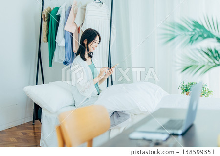 Young woman looking at smartphone in bed 138599351