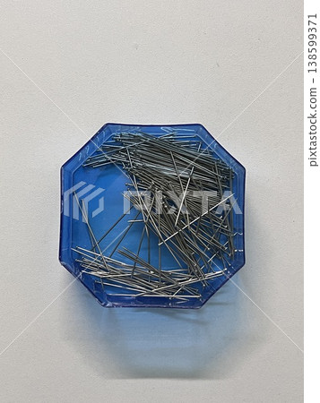 Top View Of Sewing Pins In Blue Hexagonal Plastic Container Top View Of Sewing Pins In Blue Hexagonal Plastic Container 138599371