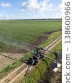 Autonomous machine is moving watering pivot along irrigation canal. 138600966
