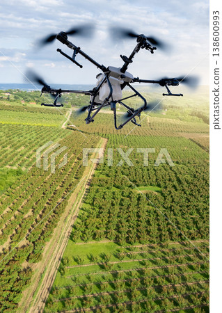 Drone sprayer flies over the agricultural field. Smart farming and precision agriculture. 138600993