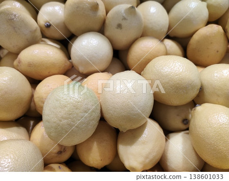 Fresh Organic Lemons in a Vibrant Pile Displayed at a Farmer's Market, Showcasing Their Natural Yellow Color and Textured Skin Fresh Organic Lemons in a Vibrant Pile Displayed at a Farmer's Market, Showcasing Their Natural Yellow Color and Textured Skin 138601033