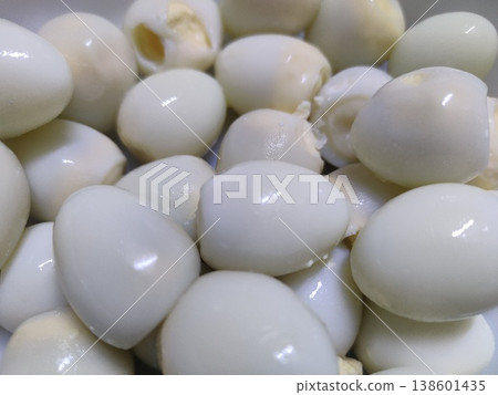 Close-Up View of Freshly Boiled White Quail Eggs in a Bowl, Showing Smooth Texture and Varied Shapes, Highlighting Natural Culinary Ingredients Close-Up View of Freshly Boiled White Quail Eggs in a Bowl, Showing Smooth Texture and Varied Shapes, Highlighting Natural Culinary Ingredients 138601435