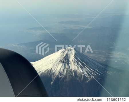 Beautiful snow-capped mountains as seen from an airplane. Beautiful snow-capped mountains as seen from an airplane. 138601552