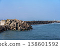 A harbor scene with seawalls and breakwaters lining the coast. 138601592
