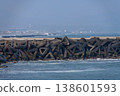 A harbor scene with seawalls and breakwaters lining the coast. 138601593