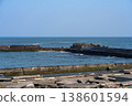 A harbor scene with seawalls and breakwaters lining the coast. 138601594