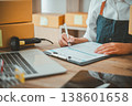Small SME business owners work with laptop computers at work. and have products ready to ship. customers have ordered of online retailers,Ecommerce 138601658