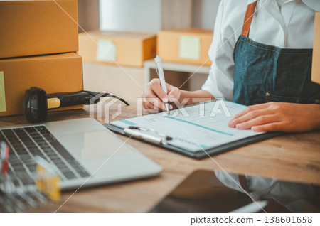 Small SME business owners work with laptop computers at work. and have products ready to ship. customers have ordered of online retailers,Ecommerce Small SME business owners work with laptop computers at work. and have products ready to ship. customers have ordered of online retailers,Ecommerce 138601658
