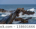A breakwater with waves crashing against it and dilapidated wave-dissipating blocks: a scene of port infrastructure. 138601666