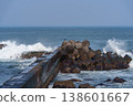 A breakwater with waves crashing against it and dilapidated wave-dissipating blocks: a scene of port infrastructure. 138601667