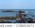 A breakwater with waves crashing against it and dilapidated wave-dissipating blocks: a scene of port infrastructure. 138601671