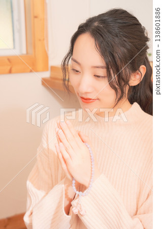 A daughter prays for her deceased loved one at home (retro style) A daughter prays for her deceased loved one at home (retro style) 138601886