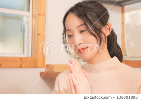 A daughter prays for her deceased loved one at home (retro style) A daughter prays for her deceased loved one at home (retro style) 138601890