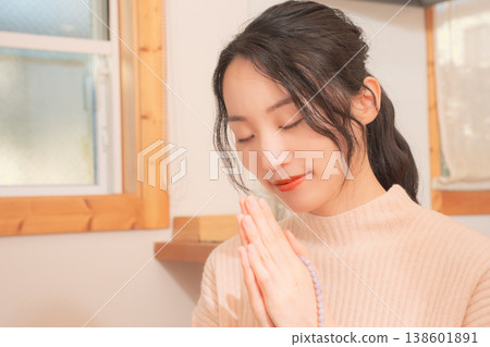 A daughter prays for her deceased loved one at home (retro style) A daughter prays for her deceased loved one at home (retro style) 138601891