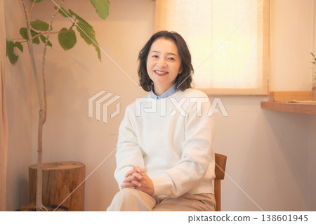 一位中年婦女(身著復古服飾)在家中為逝者祈禱後。 一位中年婦女(身著復古服飾)在家中為逝者祈禱後。 138601945