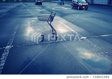 A cart left abandoned in the parking lot after the rain. A cart left abandoned in the parking lot after the rain. 138601984