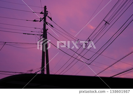 Sunset clouds, utility poles and power lines 138601987