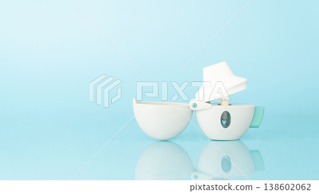 Asthma and COPD concept. Tiotropium bromide inhaler with reflection on light blue background. Pharmaceutical device of bronchodilator for lung inflammation treatment and prevent asthma attack. 138602062