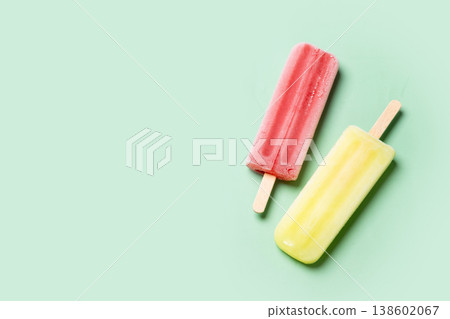Colorful fruit popsicles on green background Colorful fruit popsicles on green background 138602067