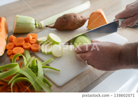 hands cutting vegetables in the kitchen. Close up hands cutting vegetables in the kitchen. Close up 138602071