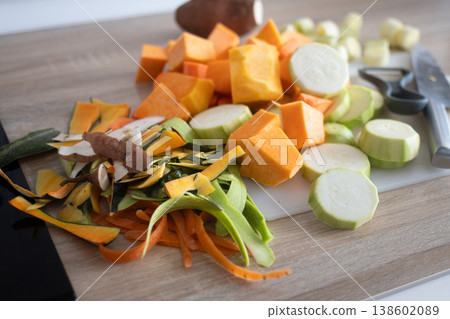 Top view of fresh vegetables being chopped on cutting board in home kitchen 138602089