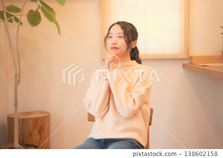 A daughter prays for her deceased loved one at home (retro style) A daughter prays for her deceased loved one at home (retro style) 138602158