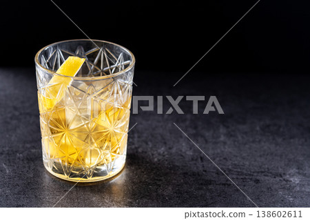 Rusty Nail Cocktail with Lemon Peel in Crystal Glass Rusty Nail Cocktail with Lemon Peel in Crystal Glass 138602611