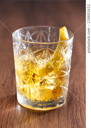 Rusty Nail Cocktail with Lemon Peel in Crystal Glass Rusty Nail Cocktail with Lemon Peel in Crystal Glass 138602612