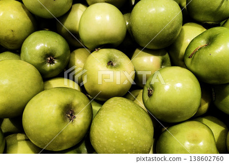 Fresh and Vibrant Green Apples Piled Together in a Market Display, Showcasing Their Juicy Texture and Natural Colorfulness 138602760