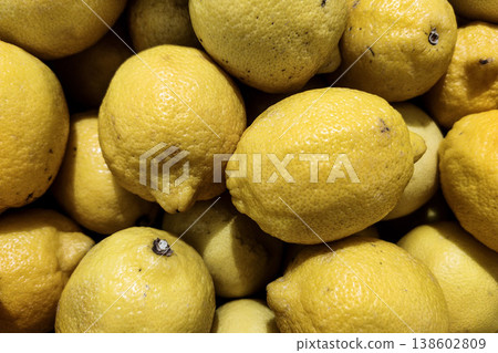 Fresh and Juicy Lemons Piled Together in a Basket for a Vibrant Market Display of Citrus Fruits in Close-Up Image Fresh and Juicy Lemons Piled Together in a Basket for a Vibrant Market Display of Citrus Fruits in Close-Up Image 138602809