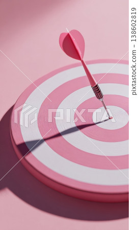 Pink dartboard with arrow hitting center Pink dartboard with arrow hitting center 138602819