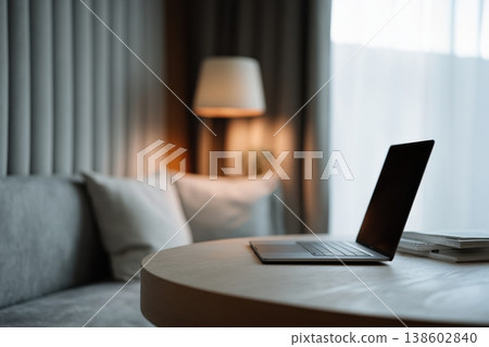 Laptop on round table in cozy minimalist living room 138602840