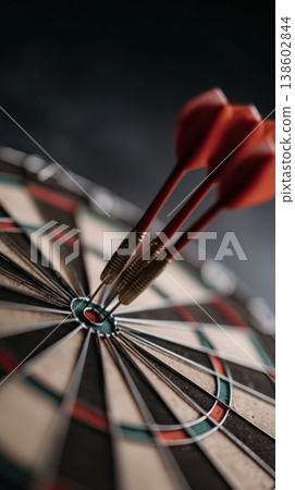 Three darts hitting bullseye on dartboard close up 138602844