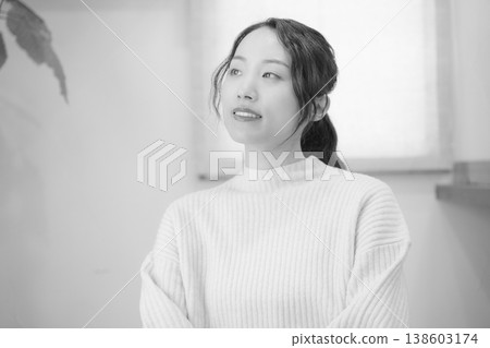 A daughter prays for her deceased loved one at home (black and white) A daughter prays for her deceased loved one at home (black and white) 138603174