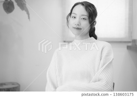 A daughter prays for her deceased loved one at home (black and white) A daughter prays for her deceased loved one at home (black and white) 138603175